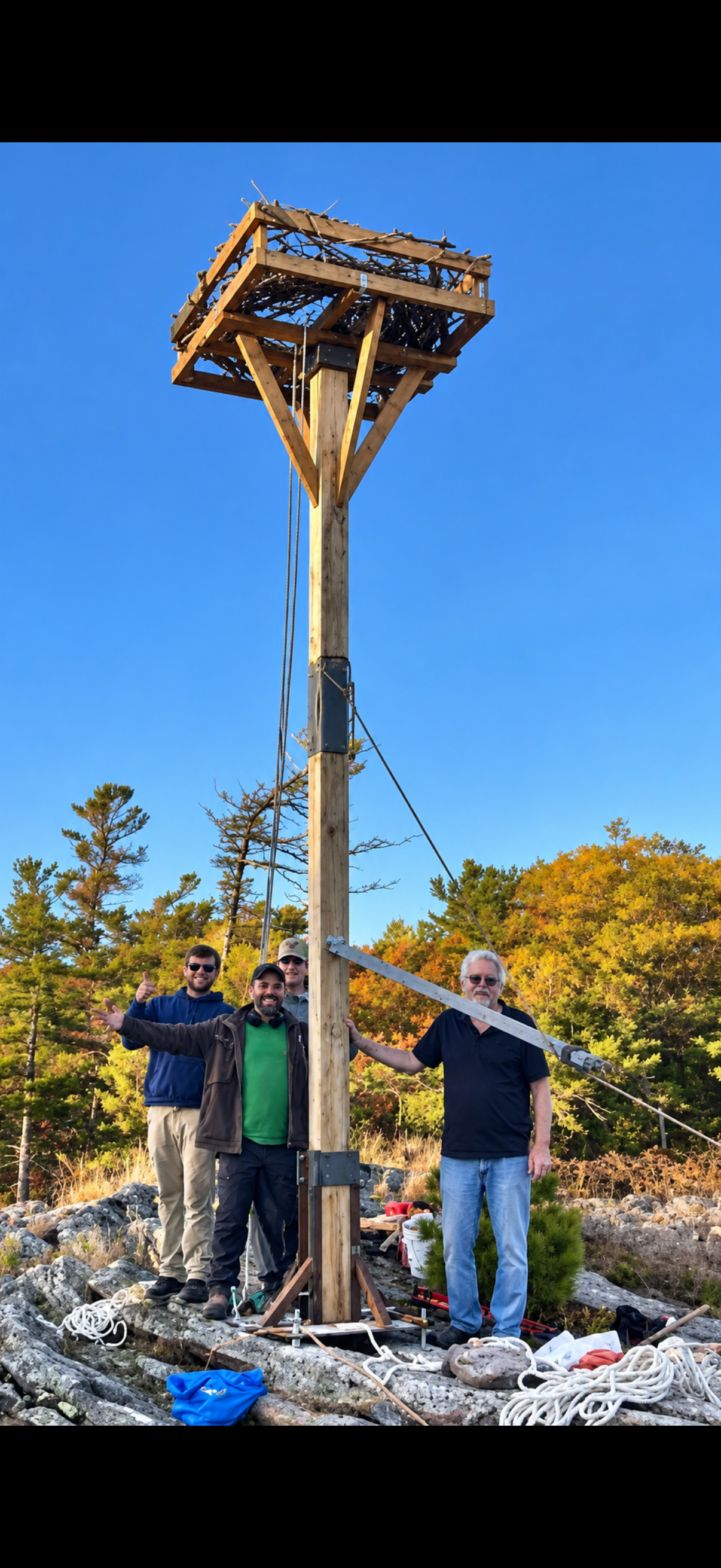 Volunteers beside the completed osprey nesting platform